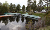 The water level of Pelican Lake had risen almost to the roofs of these boathouses at Frog Rapids Camp, when observed on May 28.    Tim Brody / Bulletin Photo