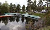 The water level of Pelican Lake had risen almost to the roofs of these boathouses at Frog Rapids Camp, when observed on May 28. Tim Brody / Bulletin Photo