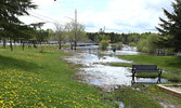 The waters of Pelican Lake seen flooding portions of the Travel Information Centre park and the Umfreville Trail.   Tim Brody / Bulletin Photo
