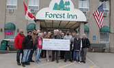 Representatives from the Forest Inn & Conference Centre, Dick and Nellie’s Bar and Grill, and the Rotary Club of Sioux Lookout present Sioux Lookout Food Bank Manager Amanda Landgraff with a $6,670 donation for the food bank raised through a recent lunch 