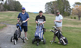 From left: Golfers Karter Sutch, Keifer Sutch, and Jeffrey Brown pose for a photo on Hole 5 on opening day, May 9.     Tim Brody / Bulletin Photo