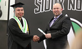 SNHS Principal Darryl Tinney (right) presents Blayne Anderson-Binguis with his diploma.   Tim Brody / Bulletin Photo