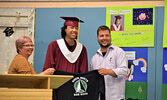 Terrance Angeconeb receives his gifted Sioux North High School hoodie from Morris Thomas Memorial School principal Pam Capay (left) and Lac Seul First Nation education director Eric Bortlis (right). - Jesse Bonello / Bulletin Photo