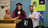 Donna Gray receives her gifted Sioux North High School hoodie from Morris Thomas Memorial School principal Pam Capay (left) and Lac Seul First Nation education director Eric Bortlis (right). - Jesse Bonello / Bulletin Photo