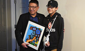 Nishnawbe Aski Nation Grand Chief Alvin Fiddler (left) presenting IFNA Student Residence Ambassador Leroy Kakegamic with a gift to put up in the new student dwellings. - Jesse Bonello / Bulletin Photo