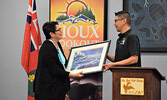 Lac Seul First Nation member Patricia Phipps-Walker (left) received a gift from the Lac Seul First Nation Band and Council during the conference. She returned to Lac Seul after nearly 60 years of being away. - Jesse Bonello / Bulletin Photo