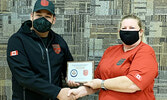 Junior Canadian Ranger Daniel Bottle, left, receives a cheque for $1,000 to further his education and a plaque from Master Corporal Lori Kendall on behalf of the Canada Company. - Photo Courtesy Ranger Jeremy Funk