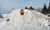 Children took advantage of warmer than average January temperatures to get in a bit of sliding fun. - Bulletin File Photo