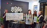 Janet Paterson (right) receiving a Sioux Travel voucher from her FIREFLY friends and colleagues. - Jesse Bonello / Bulletin Photo