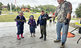 From left: cousins Olivia Genge, Sophie Genge, and Griffey Gould show their catch to Tournament Director Jeremy Funk. Tim Brody / Bulletin Photo