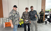 Taking first place in the Over 12 category was the team of Cooper (centre) and Derrick Sawdo (right) with a total catch weight of 8.05 pounds. Presenting them with their prize is Tournament Director Jeremy Funk. Tim Brody / Bulletin Photo