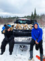 School students Bella and Joni Trout sitting in the back of a pick-up truck loaded with firewood. - Waninitawingaang Memorial School / Submitted Photos