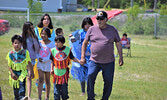Elder Rod Wesley Sr. (right) led children in dance during the powwow. - Jesse Bonello / Bulletin Photo