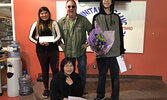 From left: Second place winner Kaylee Kejick, speech contest organizer, teacher Sean Tudor, and first place winner Cole Trout. Seated is third place winner Keira Lawson. - Alisha Dasti-Hill / Submitted Photo 