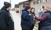 Melody McKiver (right) offers Ivory Tuesday (second from left) an opportunity to smudge as part of the peaceful rally. - Tim Brody / Bulletin Photo