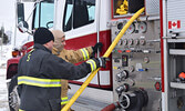 Firefighters from St. Catharines, Ontario, who donated the new fire truck, gave Lac Seul firefighters hands on training on the trucks’ features and capabilities. - Jesse Bonello / Bulletin Photo