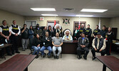 Chief Clifford Bull (seated, centre) is joined by members of his council, members of the Lac Seul Police Service Board, Lac Seul Police Service Officers, members of the OPP, and newly sworn in LSPS Chief of Police Bruno Rossi along with his wife Nicki Ros