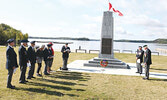 Sioux Lookout Legion President Kirk Drew [third from right] leads a memorial service for the late Queen Elizabeth II at the Town Beach.   Tim Brody / Bulletin Photo