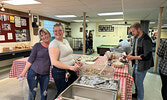 Amanda Bois (left) and Meg Brohm serve guests during the steak fry.   Tim Brody / Bulletin Photo