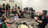 Municipal Emergency Services Manager/Fire Chief Jeremy Funk (right) speaks with visitors to the Sioux Lookout Public Library about fire safety.   Tim Brody / Bulletin Photo