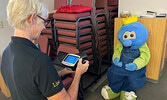 Lion Lisa Larsh screens Blueberry Festival mascot Blueberry Bert’s eyes at the Lions Kidsight Vision Screening event on August 7. The Bulletin was informed Bert passed with flying colours.    Photo courtesy of Sioux Lookout Lions Club