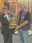 Lions Club District Governor Susan Winner (left) presents Lion Chris Larsh (right) with the Melvin Jones Fellowship Award on October 19.      Submitted Photo