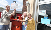 Reece Van Breda (left), Aileen Urquhart (centre) and Terry Lynne Jewell pose for a photo at the post office with the shovel and message they plan to send to Premier Doug Ford and the provincial government.    Tim Brody / Bulletin Photo