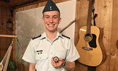 Cadet Luke Bates displays his Central Region Leadership Team  - Becky Bates / Submitted Photo Challenge Coin award. - Becky Bates / Submitted Photo 