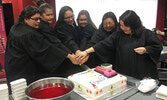 MiSW graduates cut a celebratory graduation cake / Submitted Photo