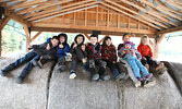 Children at the event pose for a photo atop some hay bales. - Tim Brody / Bulletin Photo