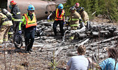 Firefighters and paramedics attend to “victims” on the scene of the training exercise, a mock plane crash. - Tim Brody / Bulletin Photo