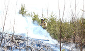 Firefighter Terry Baker extinguishes a fire created for the training exercise. - Tim Brody / Bulletin Photo
