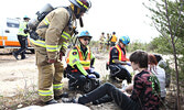 Paramedics and firefighters “provide care” for “crash victims”. - Tim Brody / Bulletin Photo