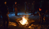 Visitors enjoyed the warm fire just outside of the Cozy Cabin on the evening of Feb. 23. - Jesse Bonello / Bulletin Photo