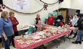 Members of the Sacred Heart Church Catholic Women’s League sell baked goods during the Moonlight Madness Market.    Tim Brody / Bulletin Photo