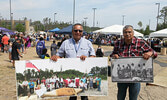 Lac Seul First Nation Chief Clifford Bull (left) and former Lac Seul First Nation Chief Tom Petawayway display photos from Lac Seul First Nation brought to the SLMHC National Indigenous Peoples Day celebration. The large photo Bull is holding is of a Trea