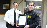 OPP North West Region Chief Superintendent/Regional Commander Bryan MacKillop (left) presents the Commissioner’s Citation for Bravery to Provincial Constable Jacob Neufeld.    Tim Brody / Bulletin Photo