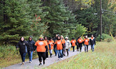 Approximately 50 participants braved chilly, and rainy, weather during their walk from the Frog Rapids Bridge to the Travel Information Centre. - Jesse Bonello / Bulletin Photos