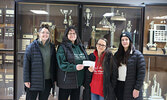 Sioux Lookout Women’s Hockey League home tourney coordinators Ashley Herfst (far left) and Kara Carter (far right) present Sioux Looks Out for PAWS Animal Rescue representatives Gisele Southwell (second from left) and Jennifer Jackobsen (second from right