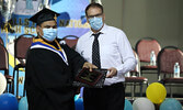 Jerico Crane receives his diploma and the Executive Director’s Award from PFFNHS Principal Darrin Head.    Tim Brody / Bulletin Photo