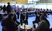 Foreground from left: Allan Walski, PFFNHS Vice-Principal Nathan Hunter, PFFNHS graduating student Thunder O’Keese, Eric Anderson and Victor Lyon play an honour song for this year’s graduating students on the PFFNHS school drum “Centre of the Earth”.   Ti