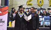 Darius Beardy-Kanakakeesic (left) receiving his diploma from Principal Solomon Kakagamic. - Jesse Bonello / Bulletin Photo
