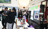  Students visit the “Launch Pad” to bid on a variety of items.   Tim Brody / Bulletin Photo