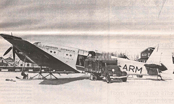 Pic of the Past: Loading cargo onto a Canadian Airways plane on Pelican Lake circa 1937
