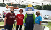 From left: Lynda Ducharme, Sioux Looks Out For Paws chairperson, Sioux Looks Out For Paws volunteer Judy Henrickson, Blueberry Festival mascot Blueberry Bert, and Sioux Looks Out For Paws volunteer Joan Dykes at a BBQ the animal rescue held on August 2. -