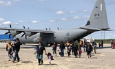 Pikangikum First Nation evacuees disembark from a Royal Canadian Air Force C-130 aircraft (“Hercules”) on May 31 in Sioux Lookout. - Tim Brody / Submitted Photo