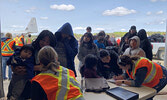 Pikangikum First Nation evacuees register at the NAPS hanger. - Tim Brody / Submitted Photo