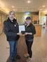 OPTA President Dean Osmond (left) presents Pink Warrior Run grand prize winner Carly Collins with her prize, a certificate for a trip for two for a Fort Garry Hotel experience.     Photo courtesy Ojibway Power Toboggan Association
