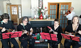 Plays with Strings members from left: Sharen Madden, Denise Williams, Alyson Martin, and Katherine Brunton. Meritt Penner in back, joined the quartet for their Facebook Live event, “Another Covid Christmas Concert.”     Screen shot of Another COVID Christ