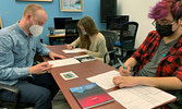 Poet Evan J (left) works with poetry workshop participants Mackenzie Angeconeb (centre) and Echo Davis (right) at the Sioux Lookout Public Library on March 1. Evan is currently working on his first novel.   Emily McIntyre / Submitted Photo